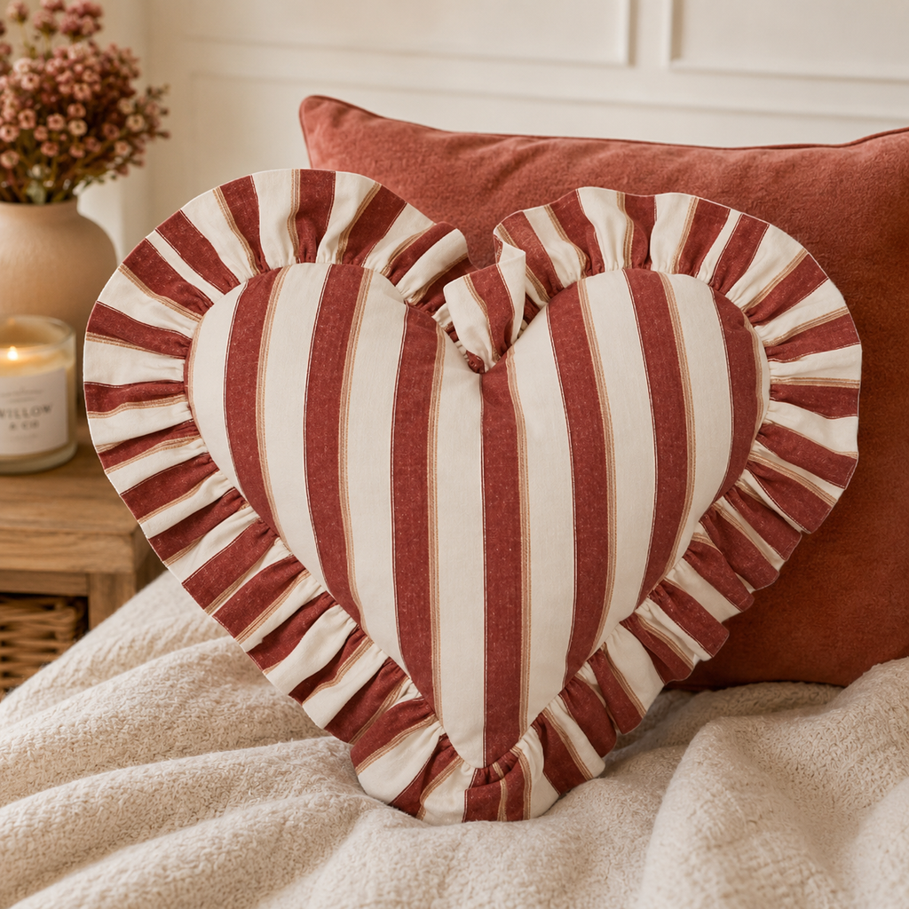 Bonny Heart cotton cushion russet styled on a sofa